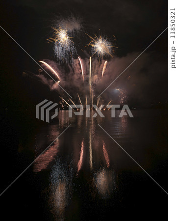 Colorful fireworks on black sky background with water reflection 11850321