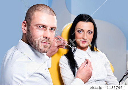 Friendly male dentist with smiling patient Friendly male dentist with smiling patient 11857964