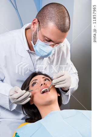 Female patient having her teeth examined by specialist Female patient having her teeth examined by specialist 11857965