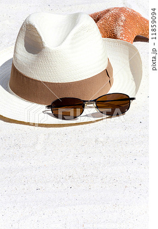 Straw Hat and a Seastar on the Beach 11859094