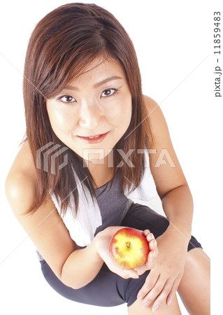 Young and fit pretty girl in exercise outfit holding red apple Young and fit pretty girl in exercise outfit holding red apple 11859483