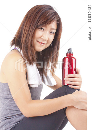 Young and fit pretty girl in exercise outfit holding red water bottle Young and fit pretty girl in exercise outfit holding red water bottle 11859484