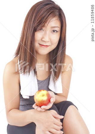 Young and fit pretty girl in exercise outfit holding red apple 11859486