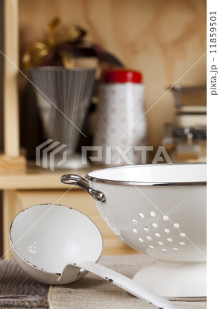 Ladle is next to a colander Ladle is next to a colander 11859501