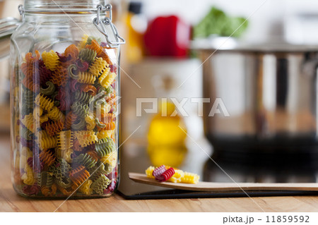 Close up view of an open Storage Jar with colorful Pasta 11859592