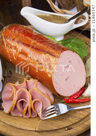 sausages on a wooden plate with vegetables in a restaurant sausages on a wooden plate with vegetables in a restaurant 11860147