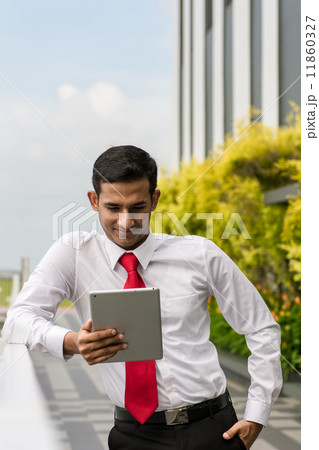 Asian businessman using digital tablet outdoor 11860327