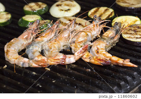 cooking shrimp kebabs on the grill in the restaurant cooking shrimp kebabs on the grill in the restaurant 11860602