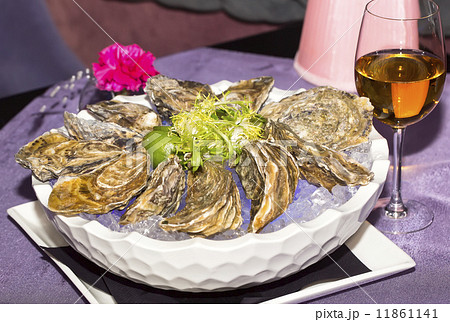 oysters on ice in a dish on a table in a restaurant oysters on ice in a dish on a table in a restaurant 11861141