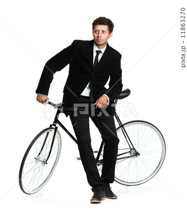 Attractive man in a classic suit with a bicycle on a white 11863270
