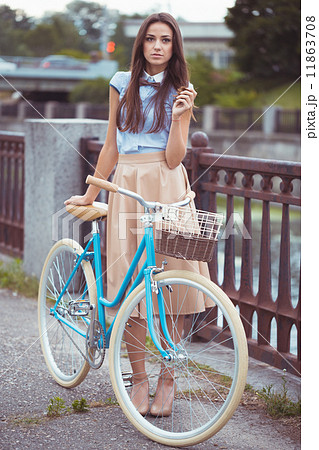 Young elegantly dressed woman with bicycle, summer and lifestyle Young elegantly dressed woman with bicycle, summer and lifestyle 11863708