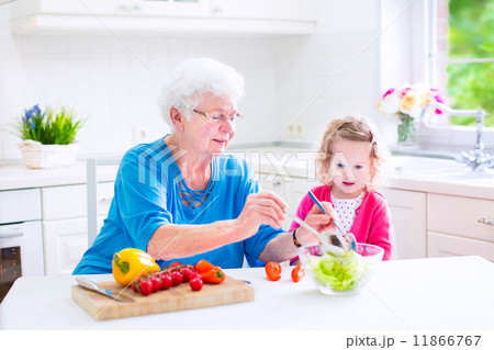 Grandmother and little girl making salad Grandmother and little girl making salad 11866767
