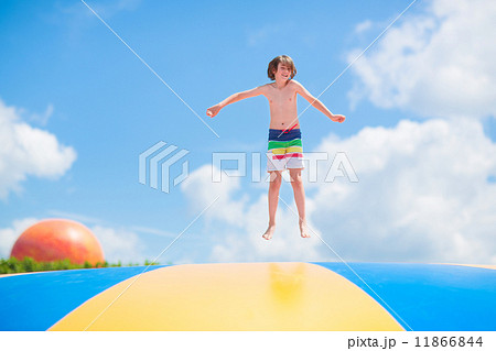 happy child jumping on a trampoline happy child jumping on a trampoline 11866844