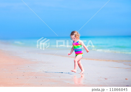 Little girl running on a beach 11866845