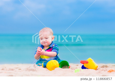 Baby boy playing on a beach 11866857