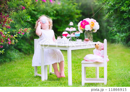 Toddler girl playing tea party with a doll Toddler girl playing tea party with a doll 11866915