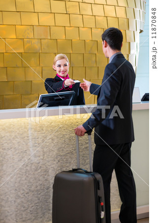 Hotel receptionist check in man giving key card 11870848