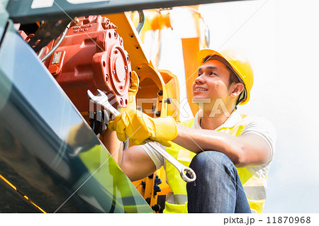 Asian mechanic repairing construction vehicle Asian mechanic repairing construction vehicle 11870968