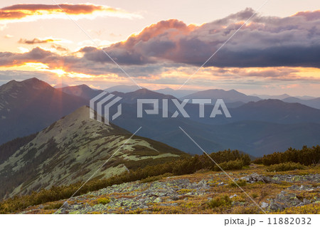 Panorama of Mountains - sunset time. Beautiful peaks, clouds an Panorama of Mountains - sunset time. Beautiful peaks, clouds an 11882032
