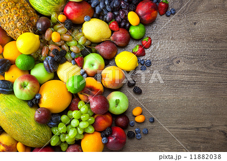 Mix of Fresh Fruits  with water drops on dark wooden table 11882038