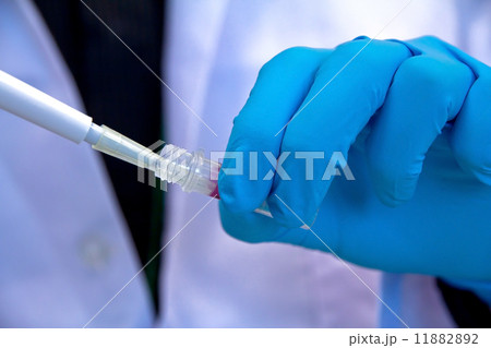 Pipette with drop of liquid in a science research lab Pipette with drop of liquid in a science research lab 11882892