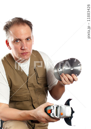 The man, the builder, chooses a detachable disk for the tool.. 11883426