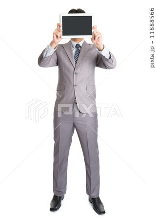 Asian businessman using computer tablet covering his face Asian businessman using computer tablet covering his face 11888566