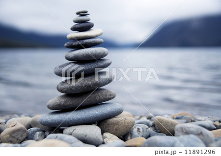 Zen Balancing Pebbles Next to a Misty Lake 11891296