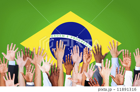 Group of Multi-Ethnic Arms Raised and a Flag of Brazil as a Back Group of Multi-Ethnic Arms Raised and a Flag of Brazil as a Back 11891316