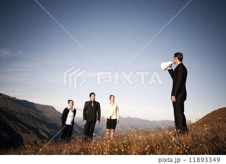Businessman Speaking Through Paper Megaphone To Business People 11893349