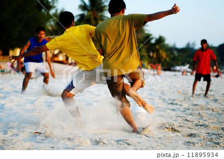 Playing Soccer on the Tropical Beach 11895934