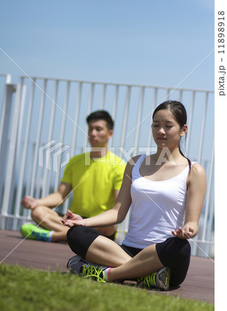 Young Asian Adults practising yoga in the city Young Asian Adults practising yoga in the city 11898918