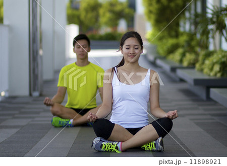 Young Asian Adults practising yoga in the city Young Asian Adults practising yoga in the city 11898921