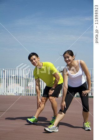 Young Asian Adults stretching during exercise Young Asian Adults stretching during exercise 11898923