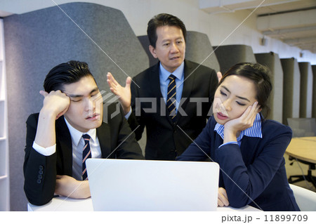 Frustrated Asian boss scolding his employees over work 11899709