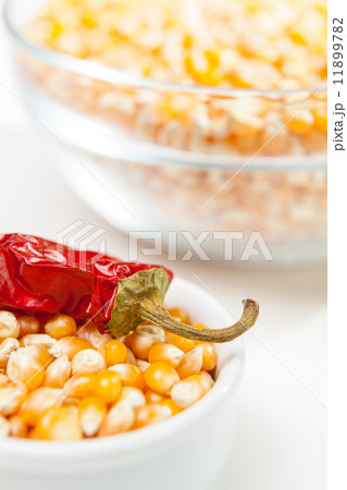 Chili pepper in a bowl of corn grain 11899782