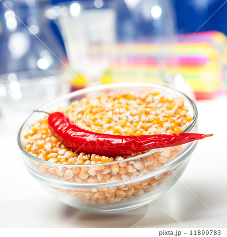 Chili pepper in a bowl of corn grain Chili pepper in a bowl of corn grain 11899783