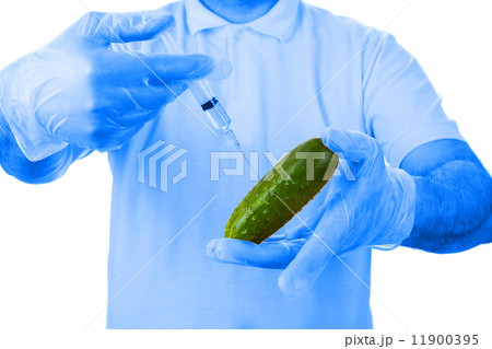 Hands making injection to cucumber Hands making injection to cucumber 11900395