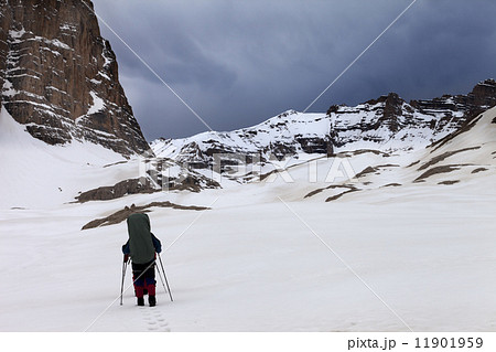 Two hikers at snowy mountains in bad weather Two hikers at snowy mountains in bad weather 11901959