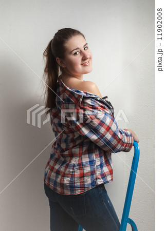 portrait of seductive woman in shirt sitting on metal ladder portrait of seductive woman in shirt sitting on metal ladder 11902008