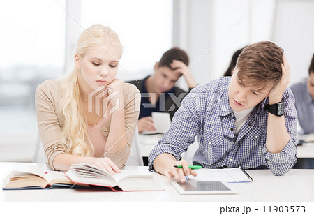 tired students with tablet pc, books and notebooks 11903573