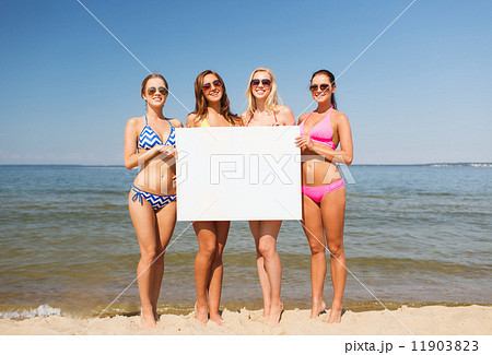 group of smiling women with blank board on beach group of smiling women with blank board on beach 11903823