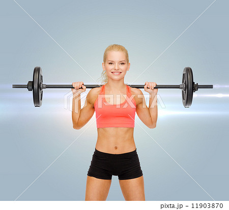 smiling sporty woman exercising with barbell smiling sporty woman exercising with barbell 11903870