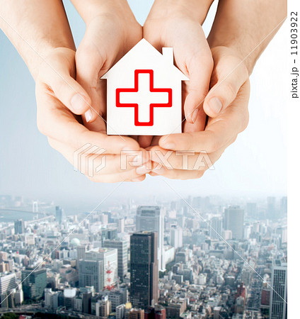 hands holding paper house with red cross hands holding paper house with red cross 11903922