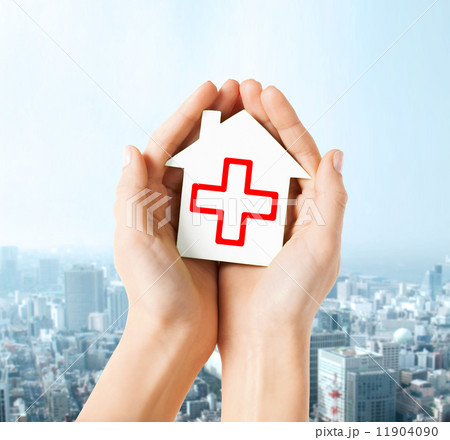 hands holding paper house with red cross hands holding paper house with red cross 11904090