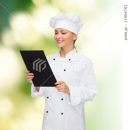 smiling female chef with black blank paper smiling female chef with black blank paper 11904761