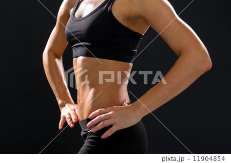 close up of athletic female abs in sportswear 11904854