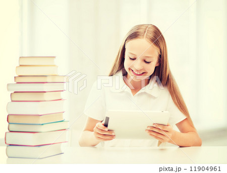 girl with tablet pc and books at school 11904961