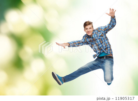 smiling young man jumping in air 11905317
