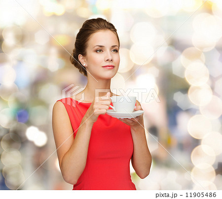 smiling woman in red dress with cup of coffee smiling woman in red dress with cup of coffee 11905486